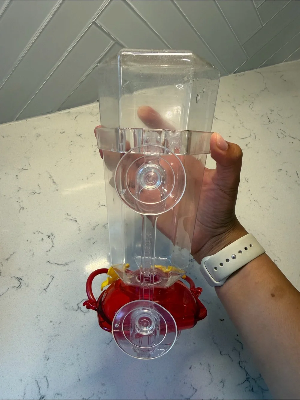 Clear Plastic Hummingbird Feeder with Red Base and Yellow Flowers
